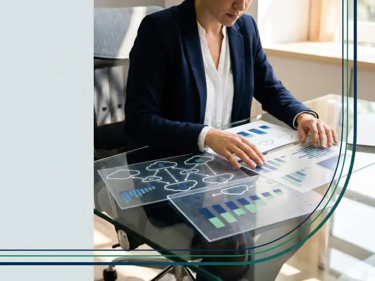 Business professional analyzing cloud infrastructure cost flow diagrams on a glass desk under warm office lighting.